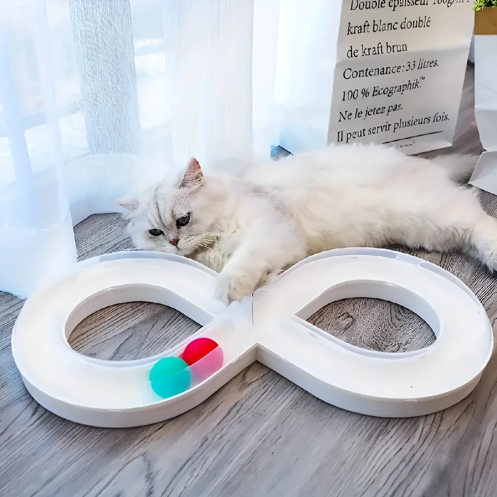 Blue and white plastic cat turntable track ball toy with a teasing stick on a flat surface.