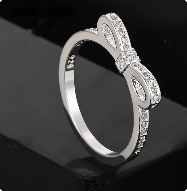 Silver bow ring with rhinestone crystals in couple style band design