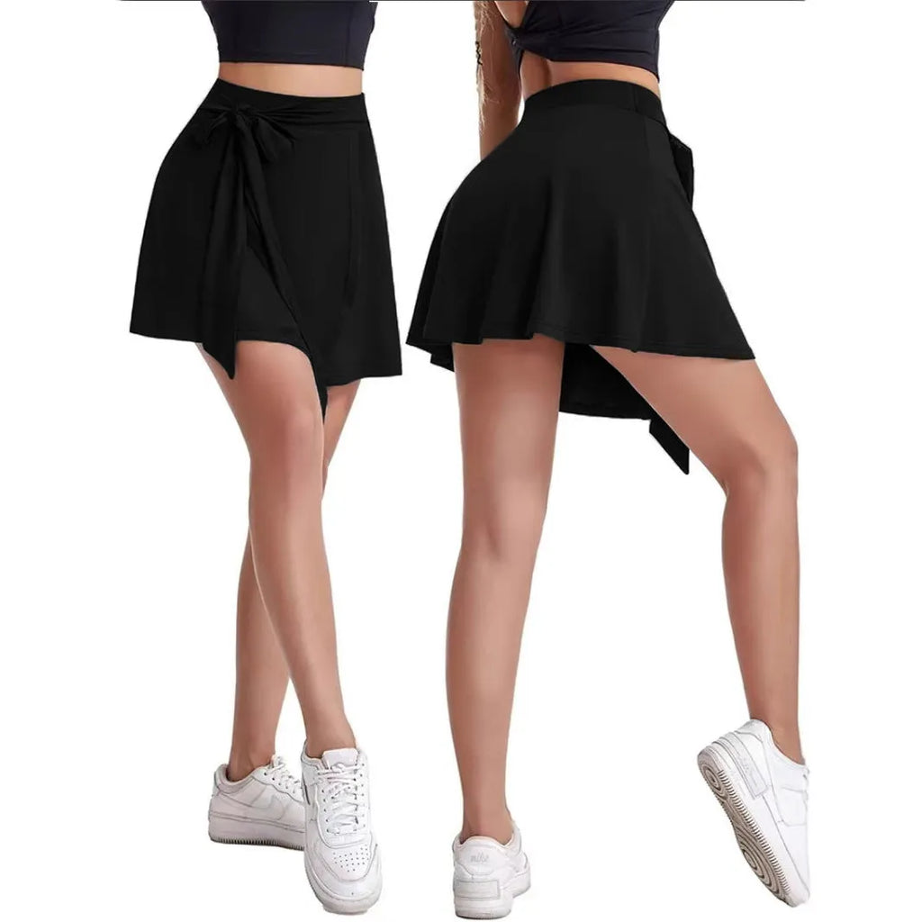 Black thigh-length culottes sports skirt with built-in shorts, high waist, and micro-elastic polyester fabric.