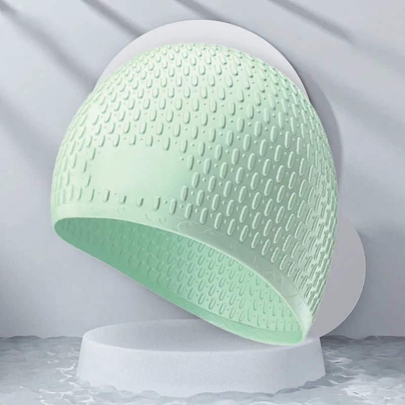 Silicone swimming cap for adults in various solid colours on a white background.