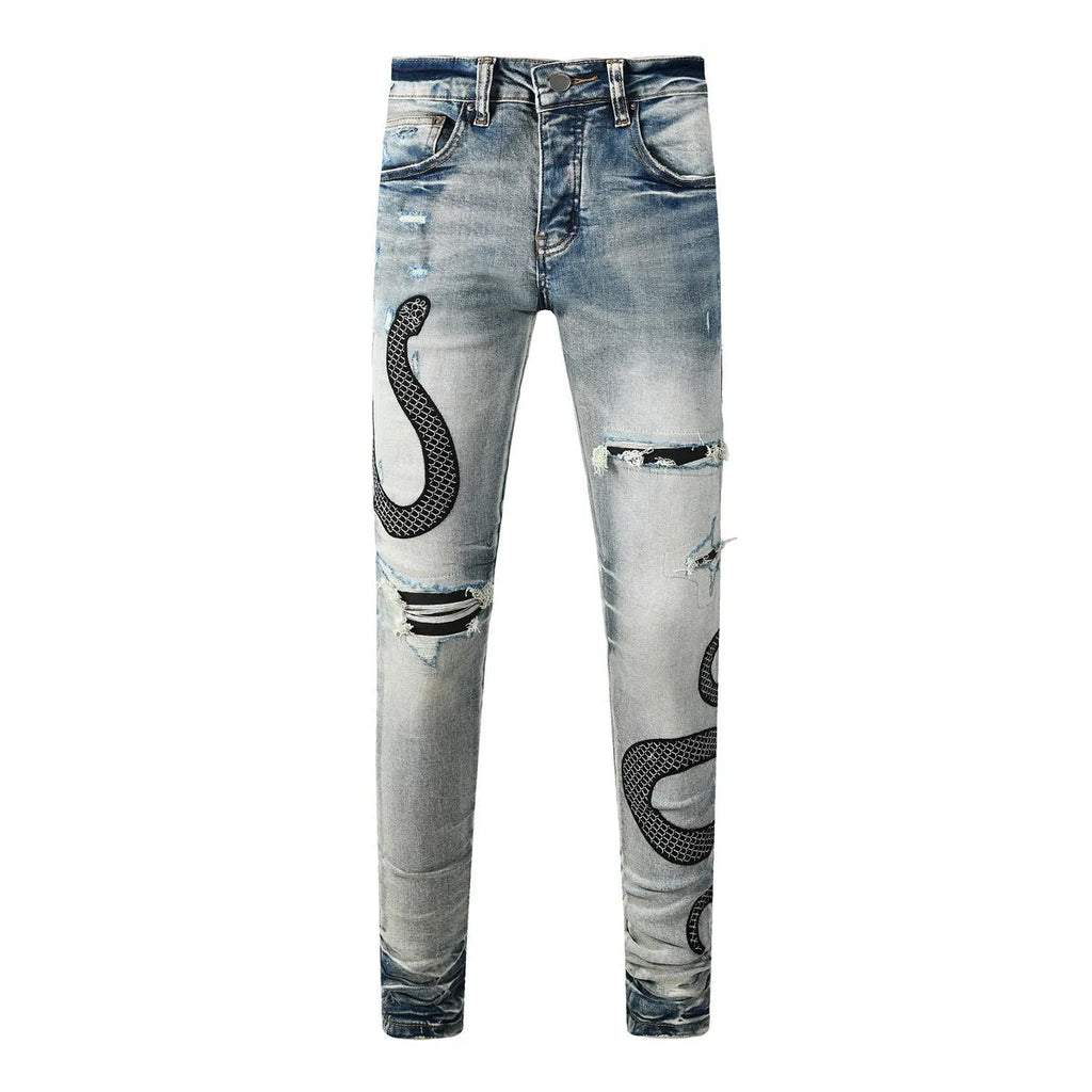 Close-up of vintage blue wash distressed skinny jeans with a tapered leg and button fly.