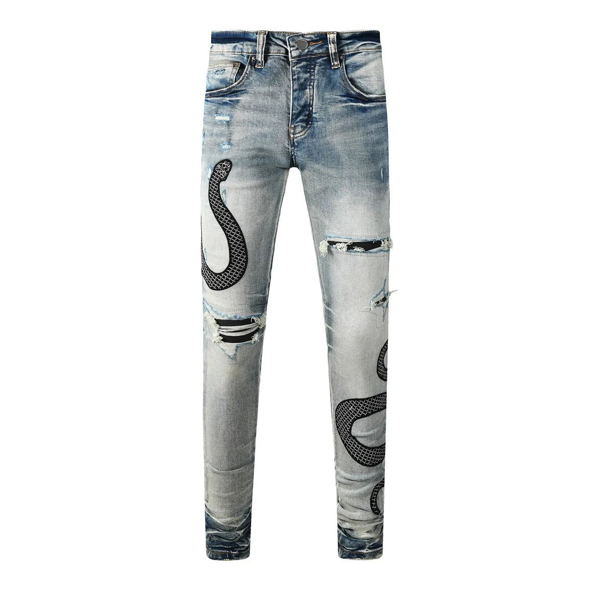 Close-up of vintage blue wash distressed skinny jeans with a tapered leg and button fly.
