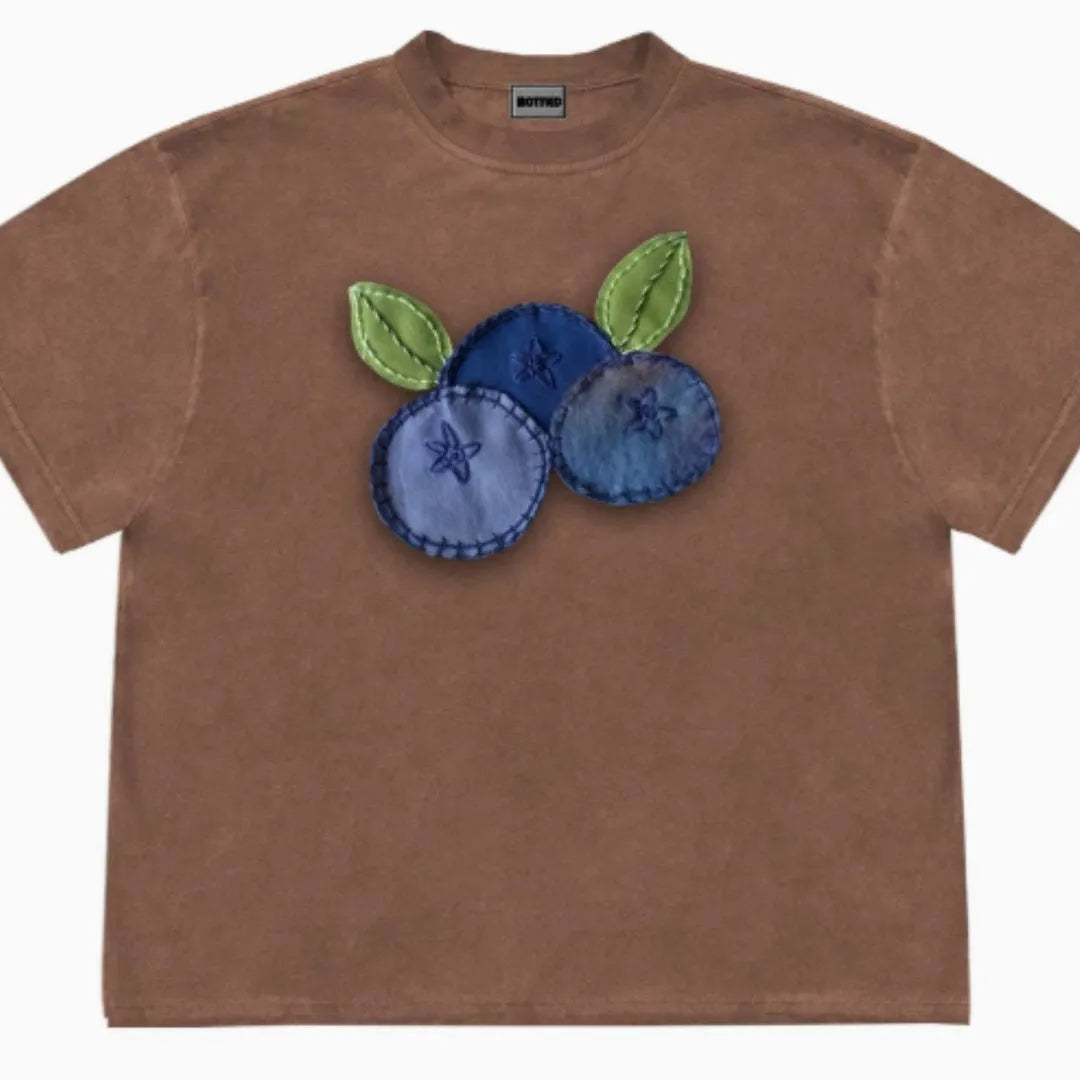 Loose fit blueberry patchwork T-shirt in ice oxygen cotton on hanger, showing floral design and short sleeves.