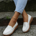 Women's flat loafers in PU leather with car-suture detail on a white background