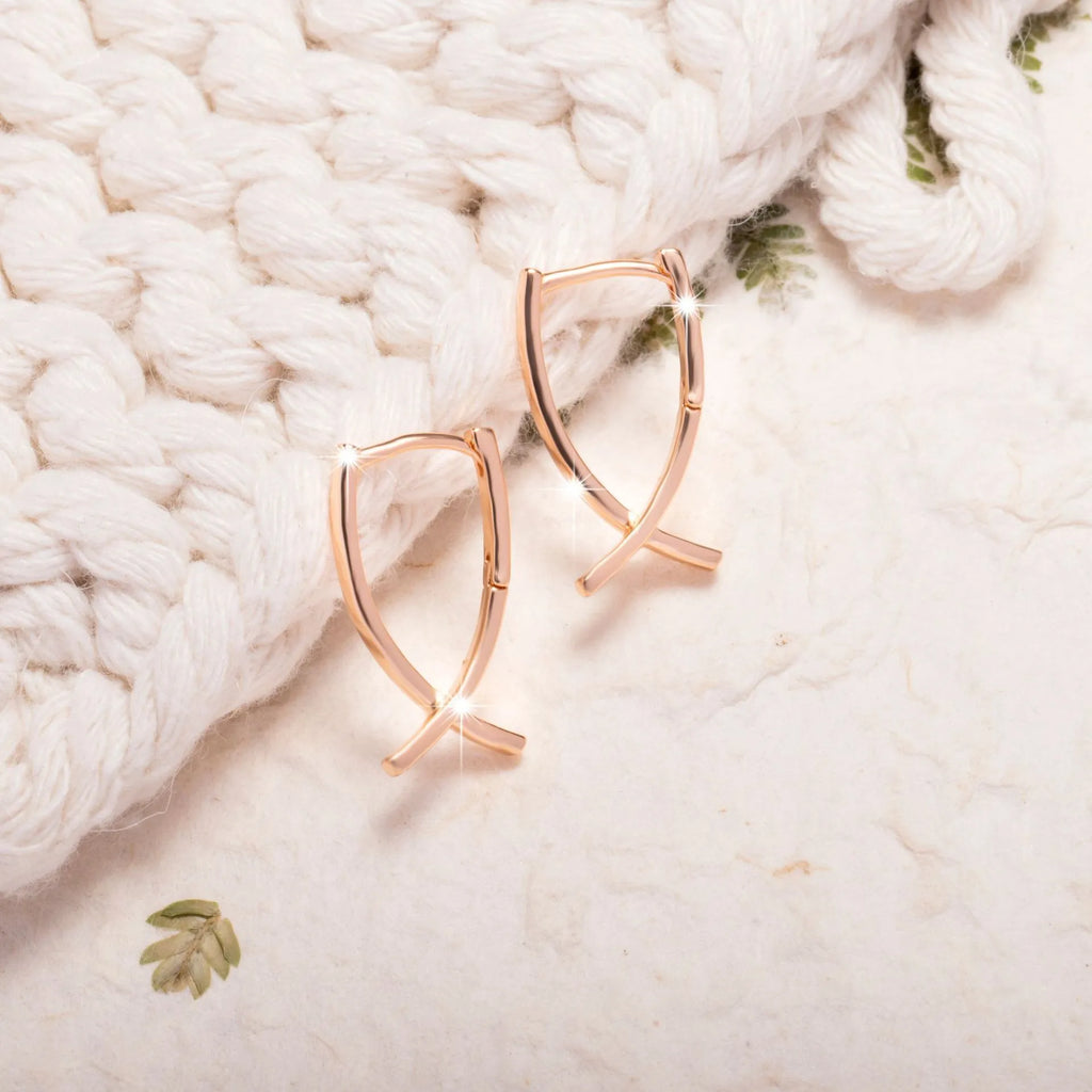 Cross shaped earrings in rose gold colour made from copper material