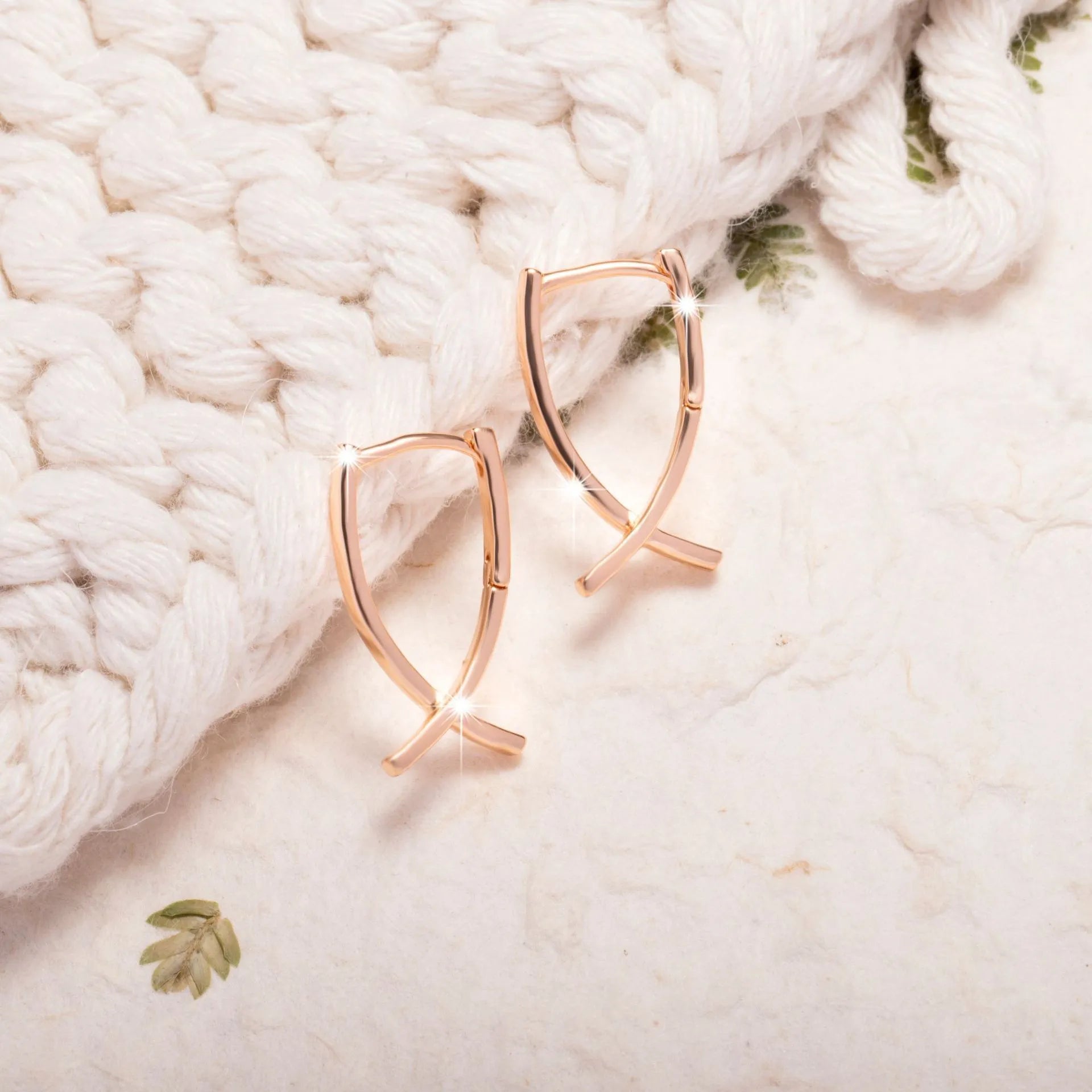 Cross shaped earrings in rose gold colour made from copper material