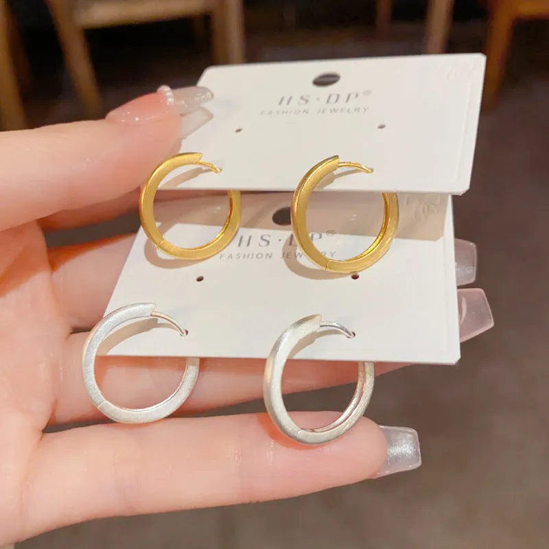 Geometric circular ear clips with gold plating in gold and silver colour options
