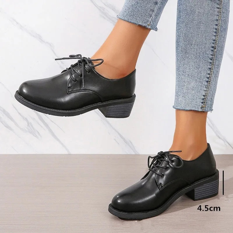 Black women's low-top work shoes with a thick chunky rubber heel and a PU leather upper