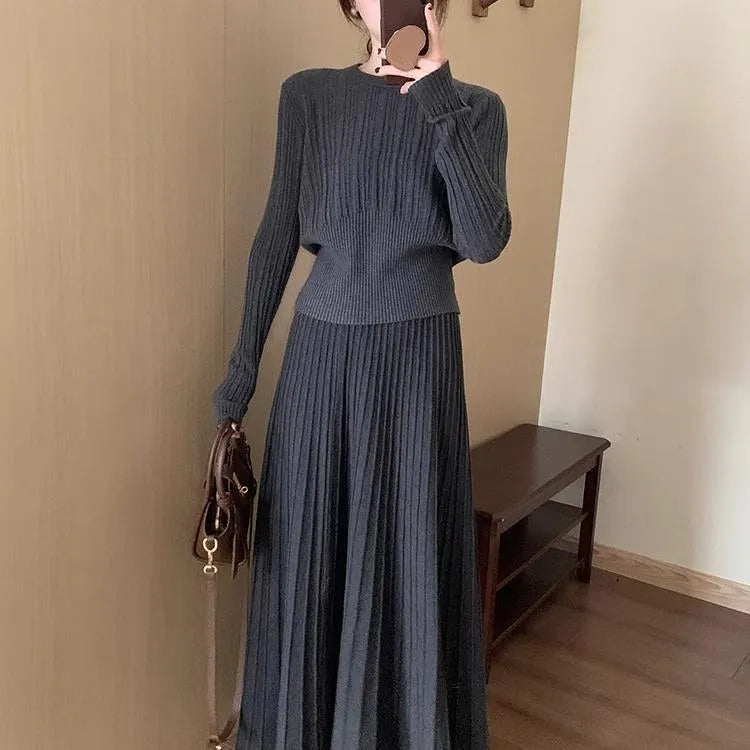 Dark grey knitted women's long dress suit with sweater, skirt, and 3D artistic pattern.