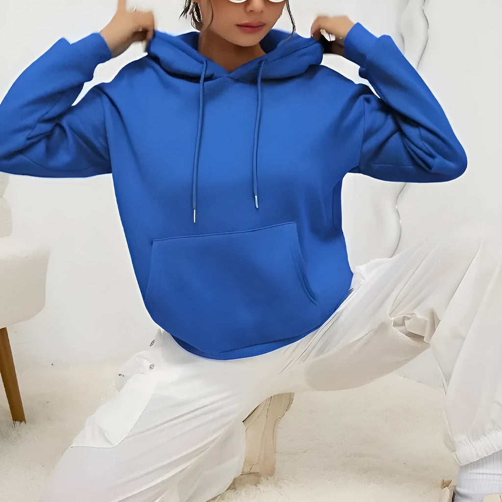 Loose grey women's sweatshirt with a drawstring waist and long sleeves on a hanger.