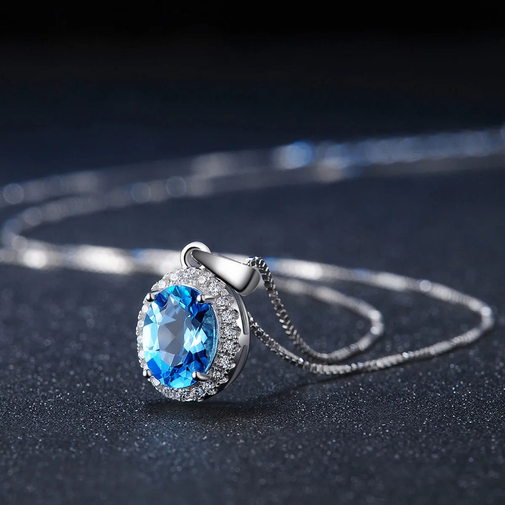 925 sterling silver geometric jewellery set with Blue Topaz gems showing necklace, earrings, ring, and pendant
