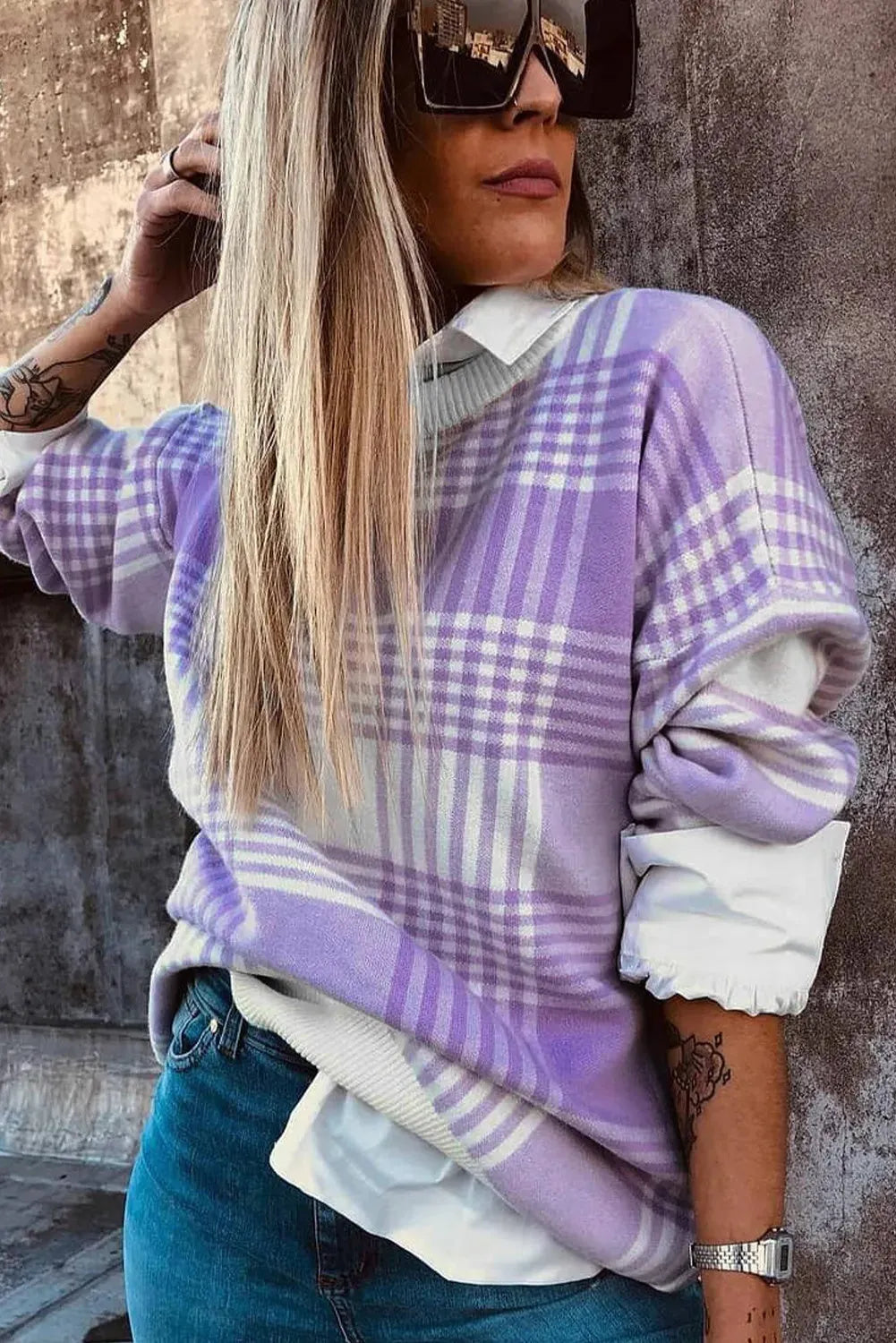 Loose lilac plaid print sweater with ribbed trim on a hanger