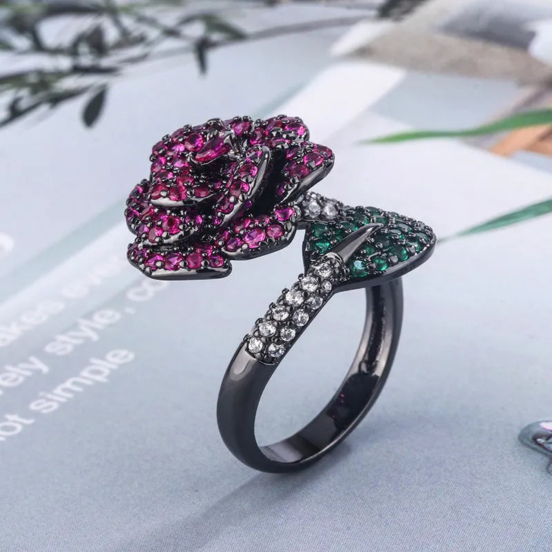 Gold-plated geometric flower ring with red simulated corundum stone on black gold finish