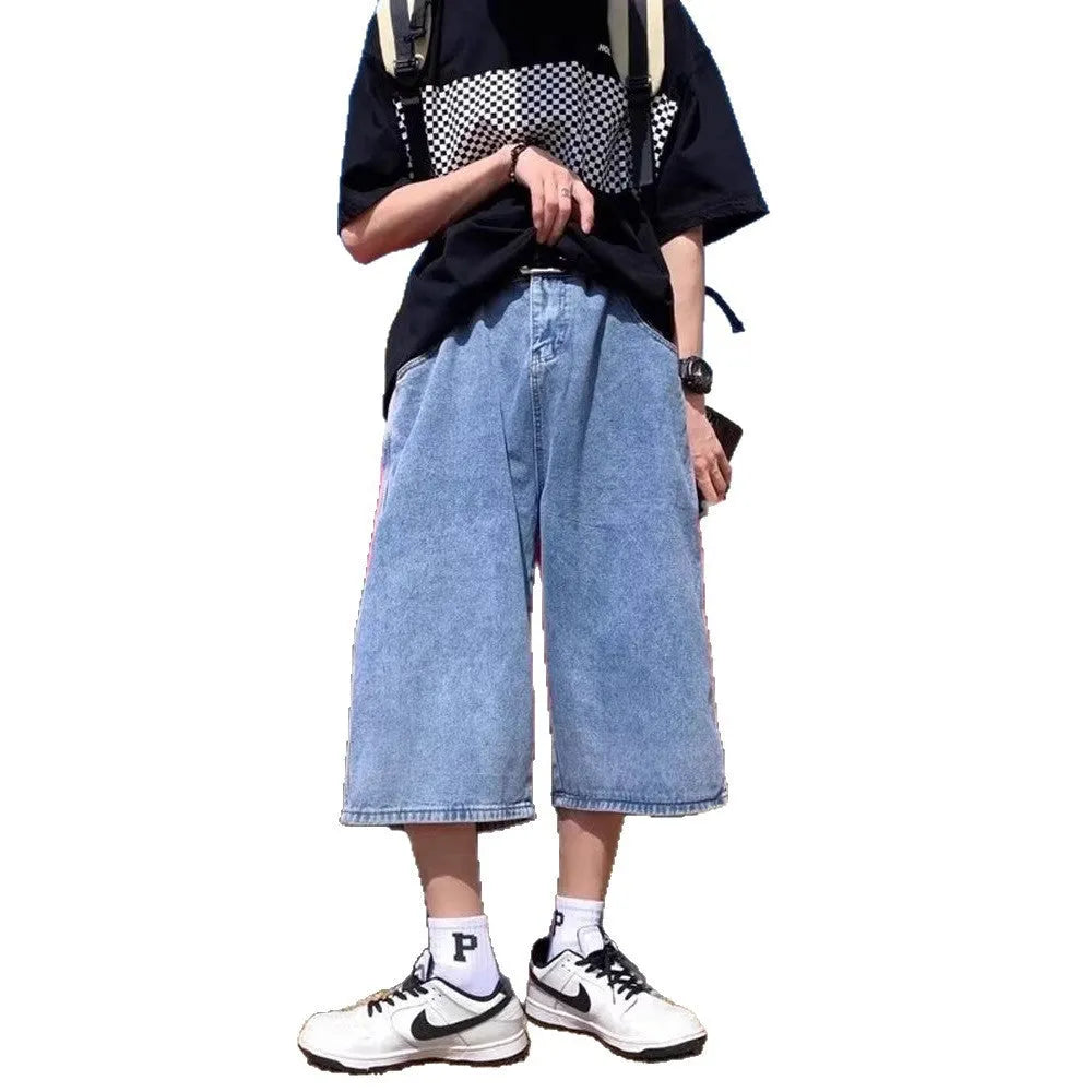 Man wearing blue high-waist straight-leg denim pirate shorts, showing cropped length and zipper fly