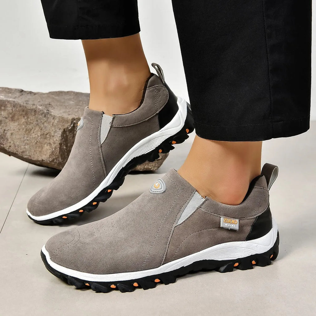 Men's grey slip-on shoes with round toe and shallow opening on rubber sole