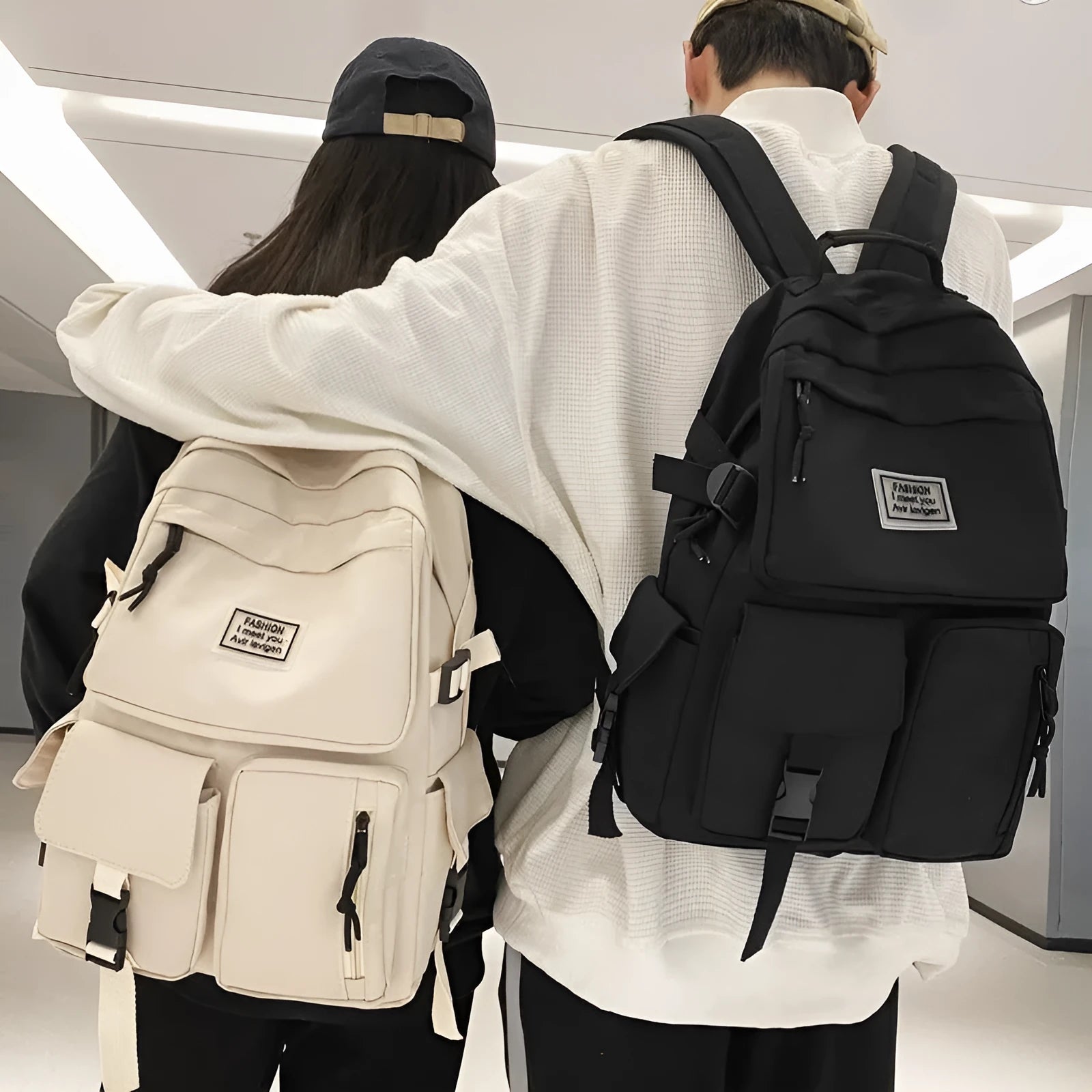 Black and white nylon student backpack with laptop compartment and three-dimensional outer pockets.