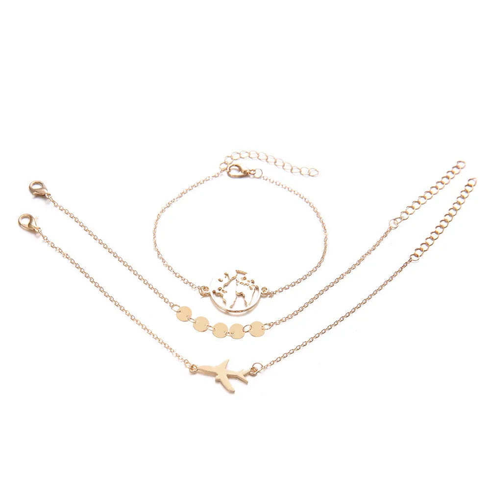 Three bohemian bracelets with heart-shaped aircraft map charms in silver tone