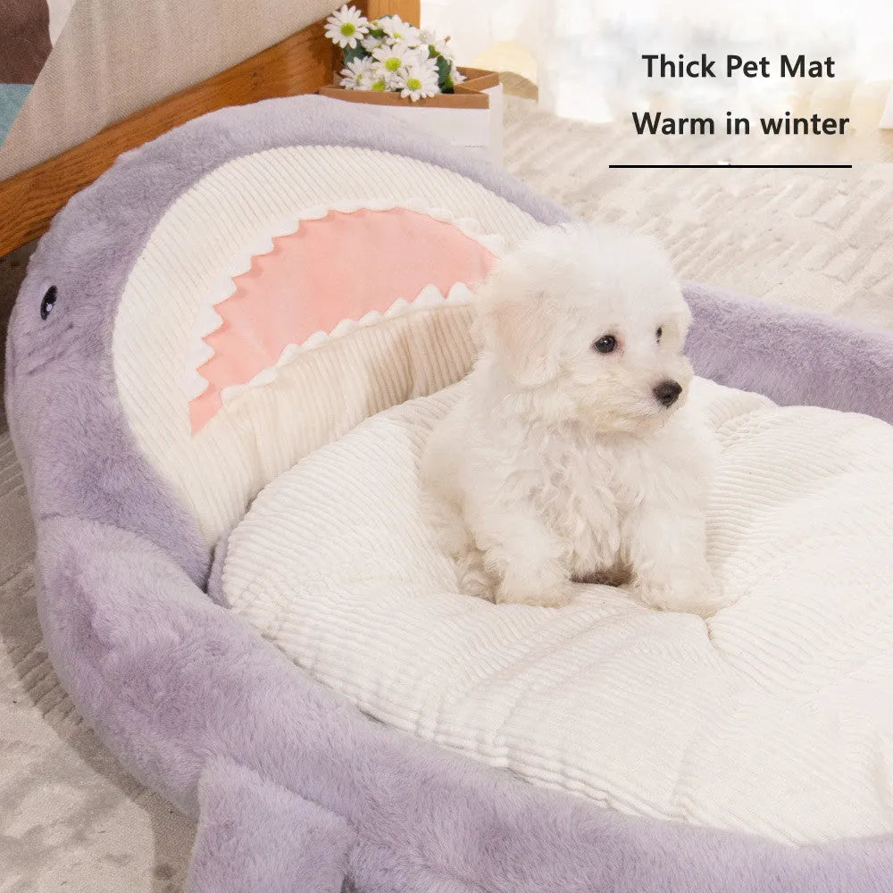 Blue shark pattern velvet pet bed for dogs or cats on a floor.