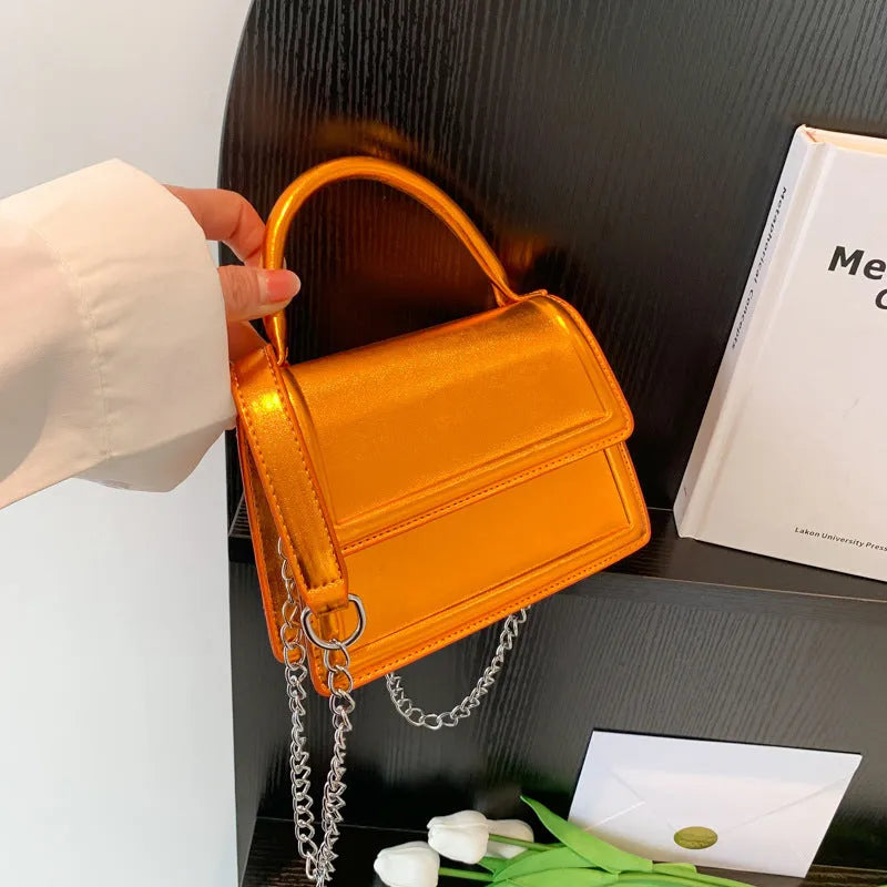 PU material crossbody shoulder bag in a horizontal square shape with visible sewing line details.