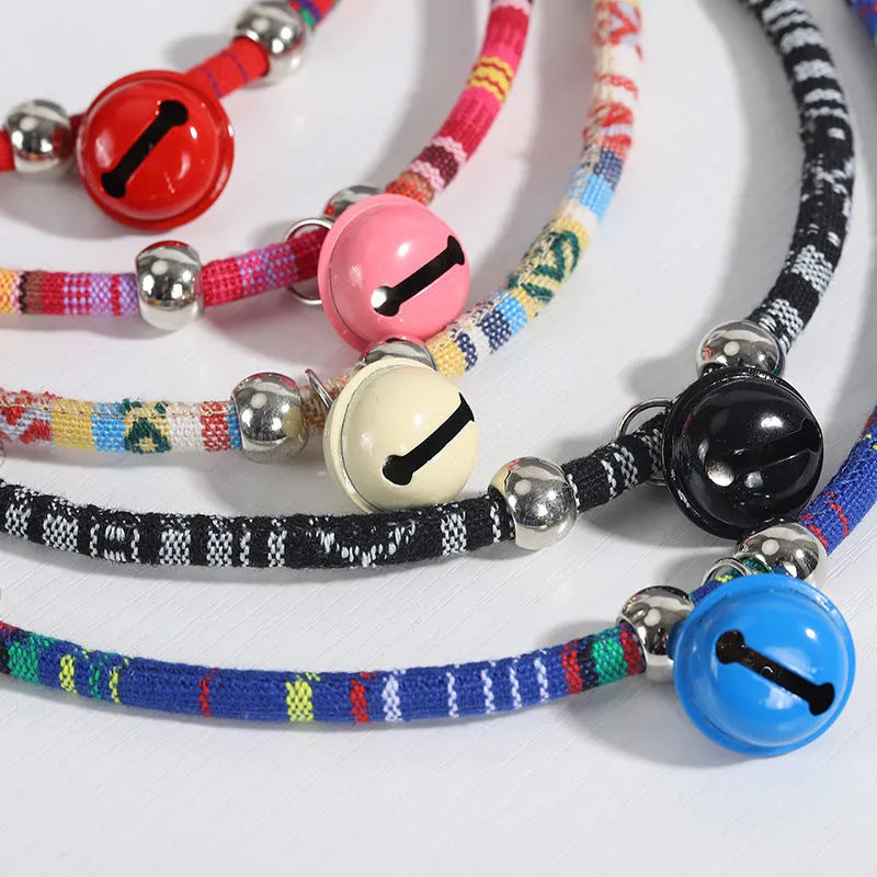 Adjustable ethnic pattern pet collar with a bell, shown in various colours for cats and small dogs.