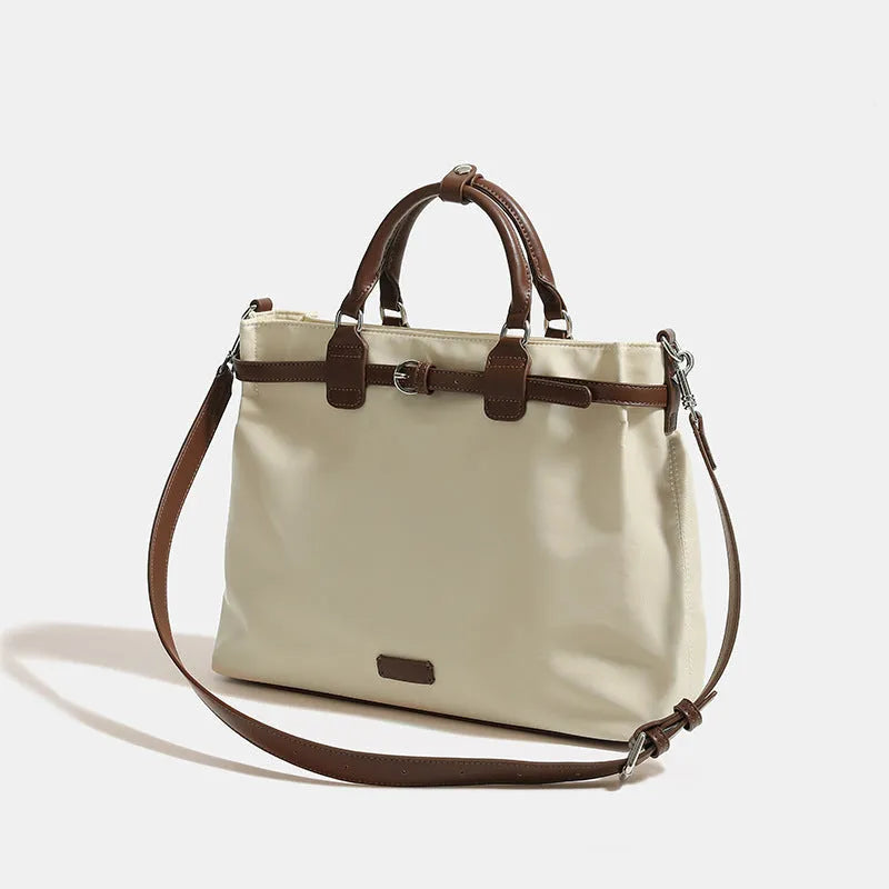 Women's nylon tote bag in creamy white with multiple internal pockets and three shoulder straps.