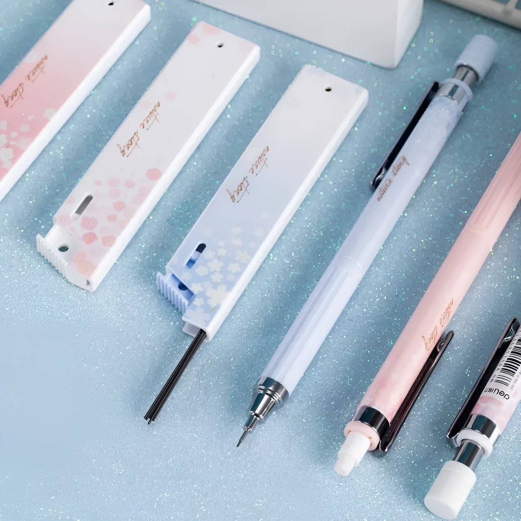 Set of three cartoon-design 0.5mm automatic pencils with boxes of HB refills.