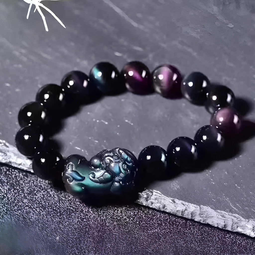 Natural ice colour obsidian crystal bracelet with spherical beads on a wrist.
