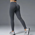 Women's peach hip tight mid waist yoga pants in solid colours for fitness and running.