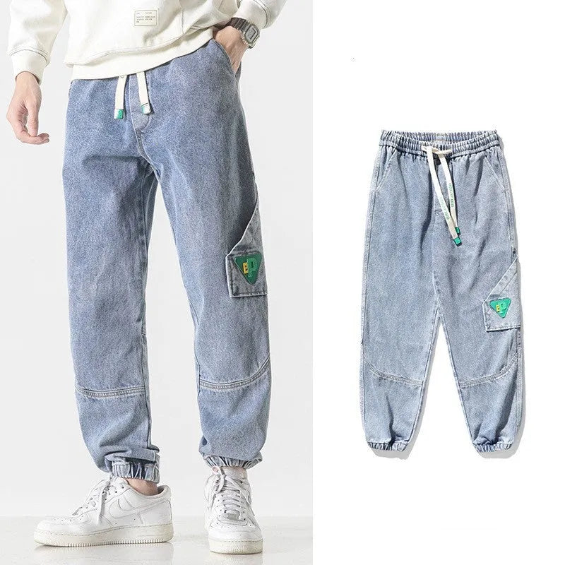 Men's loose-fit tapered cotton trousers in black, shown in a casual setting.