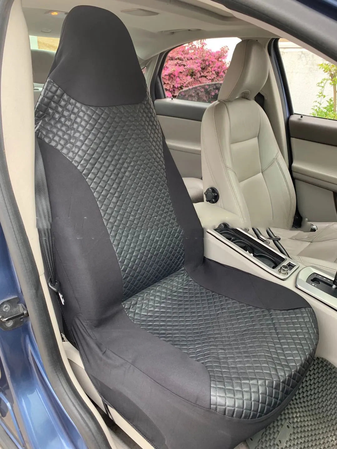 Black quilted automotive seat cover made from PU and polyester fabric on a car seat.