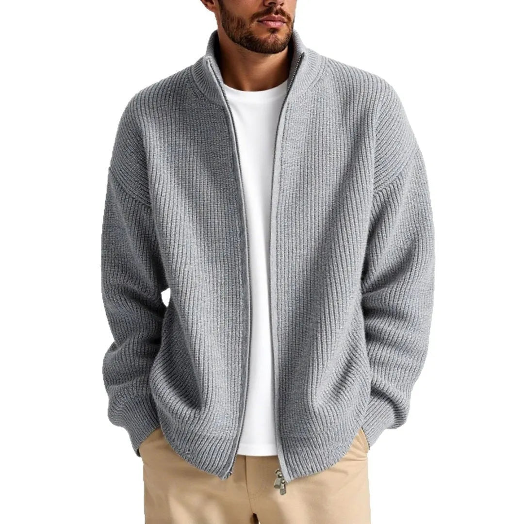 Man wearing a loose grey cardigan sweater with button-up front and V-neck.