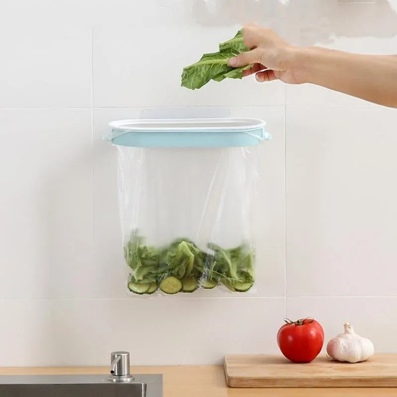Blue kitchen plastic garbage bag storage rack on a cabinet door.