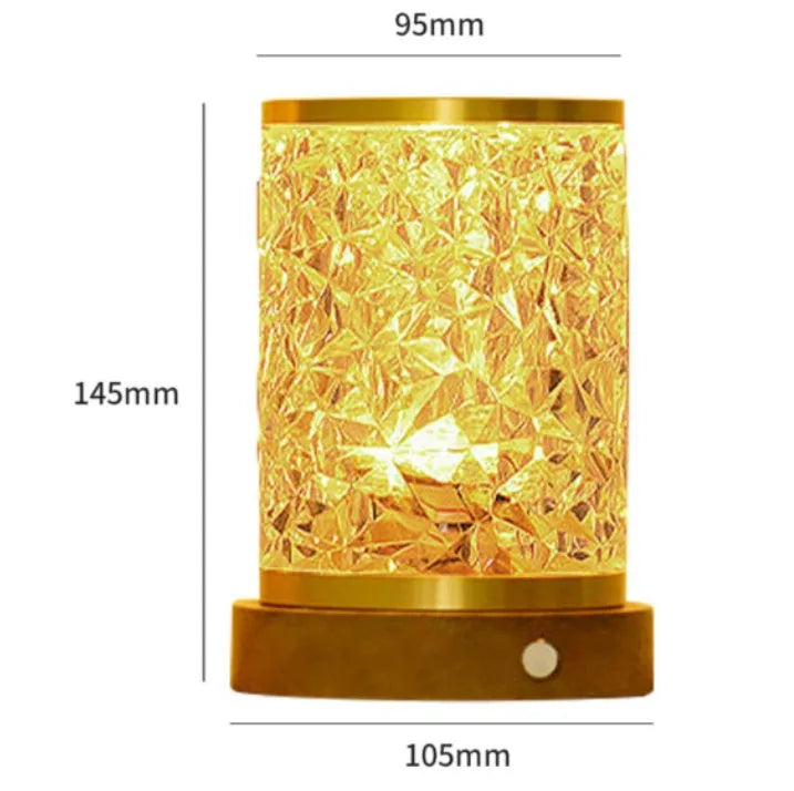 Rotating water ripple effect night light with acrylic body and solid wood base on a table.