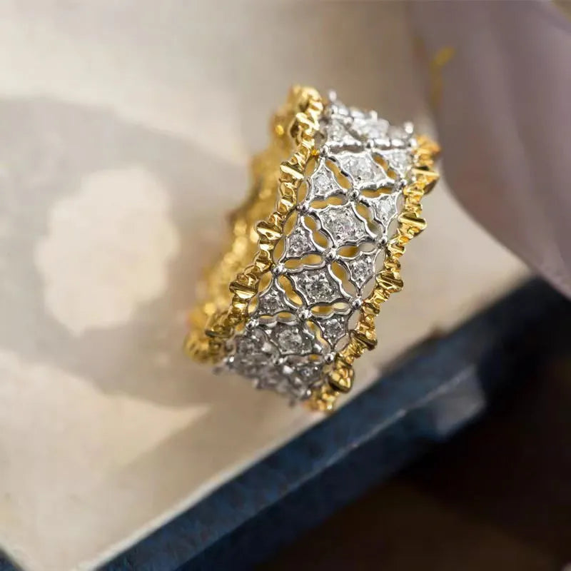 Gold two-tone geometric ring with round zircon details on a copper band.