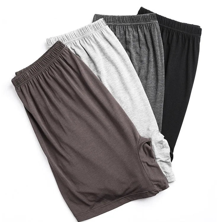 Men's solid colour high-waist modal boxers in black, blue, grey, and brown.