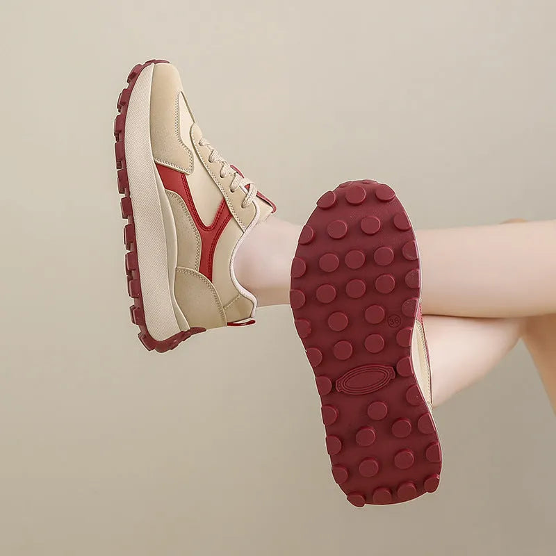 Women's solid colour low top sports shoes with flat platform heel and lace-up front.