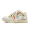 Creamy white retro low-top skate shoes with old damage lace and a platform sole