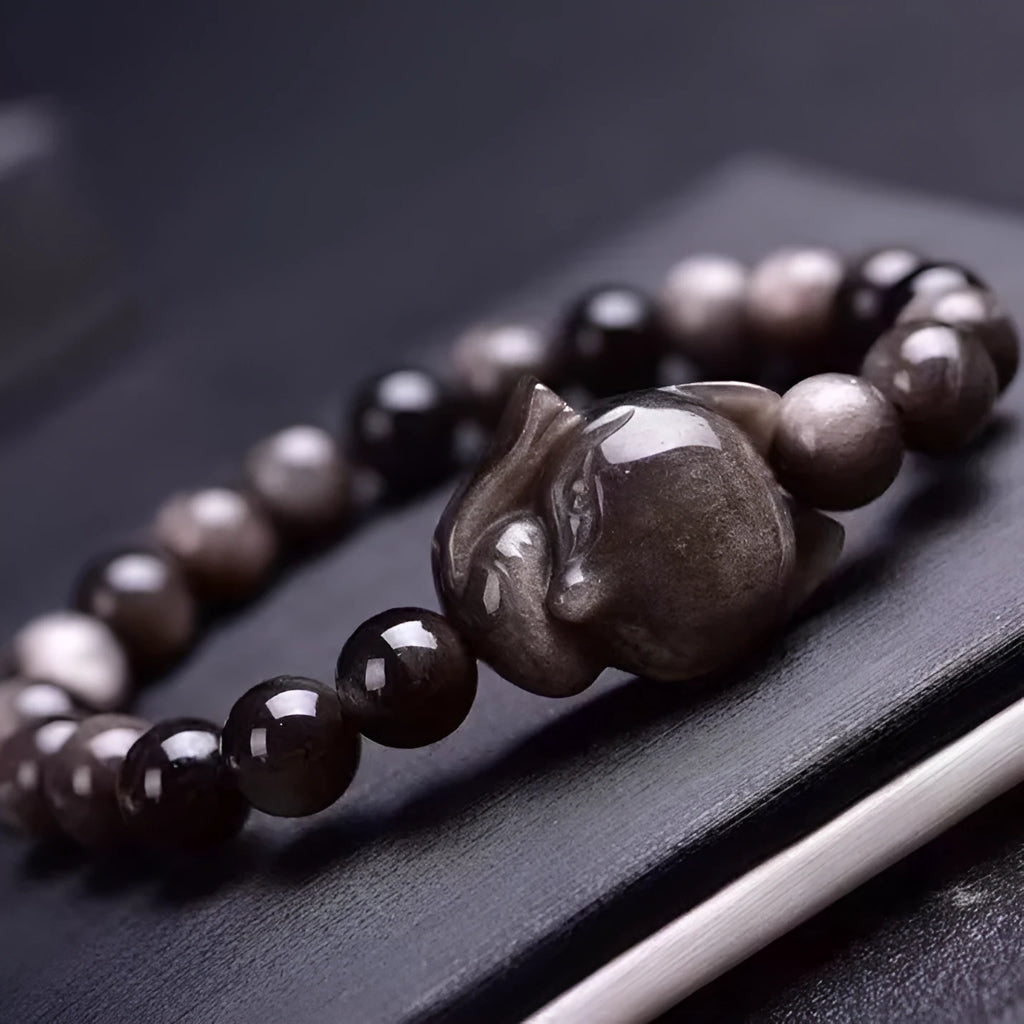 Obsidian stone bracelet with detailed fox charm on polished 8mm stone