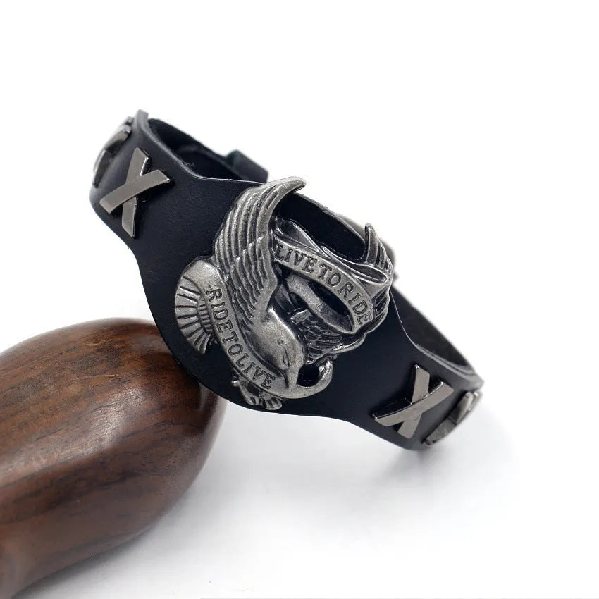 Black geometric leather bracelet with alloy eagle watch-buttom fastening showing tapered width design