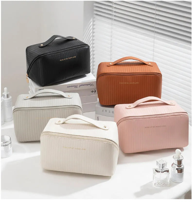 Cubic pillow-shaped PU makeup bag in a vertical pattern, shown in one of five colours: beige, black, brown, grey, or pink.