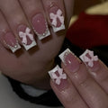 Artificial fashion nail set with white French tips, bow designs, and multiple patterns including tulip and starry sky