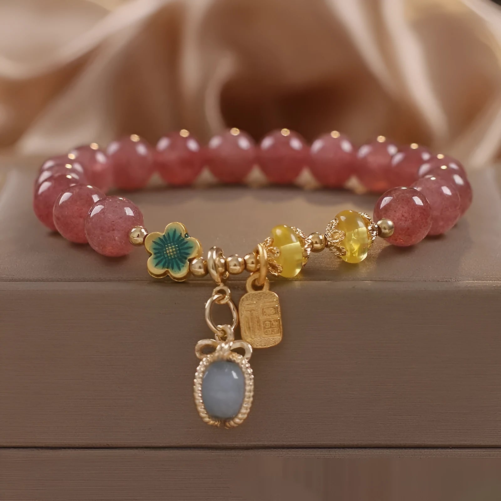Red women's bracelet with natural strawberry quartz beads and rhinestone details on alloy setting