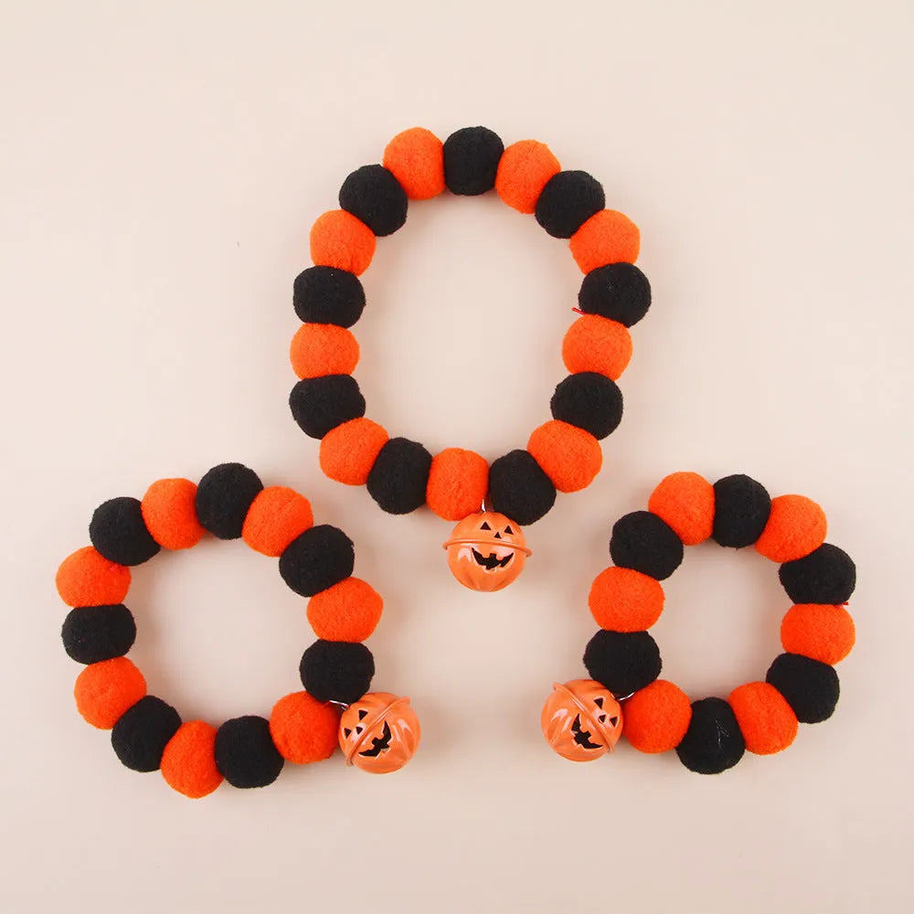 Orange Halloween pumpkin cat collar with green leaf on a breakaway safety buckle.