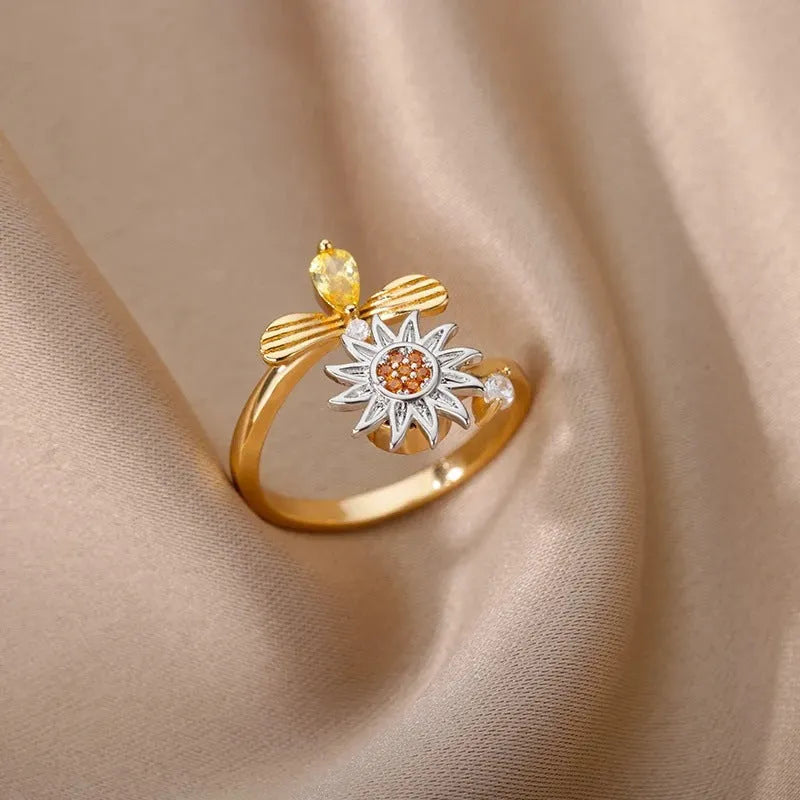 Geometric open mouth decompression ring with rotating band in gold electroplated finish