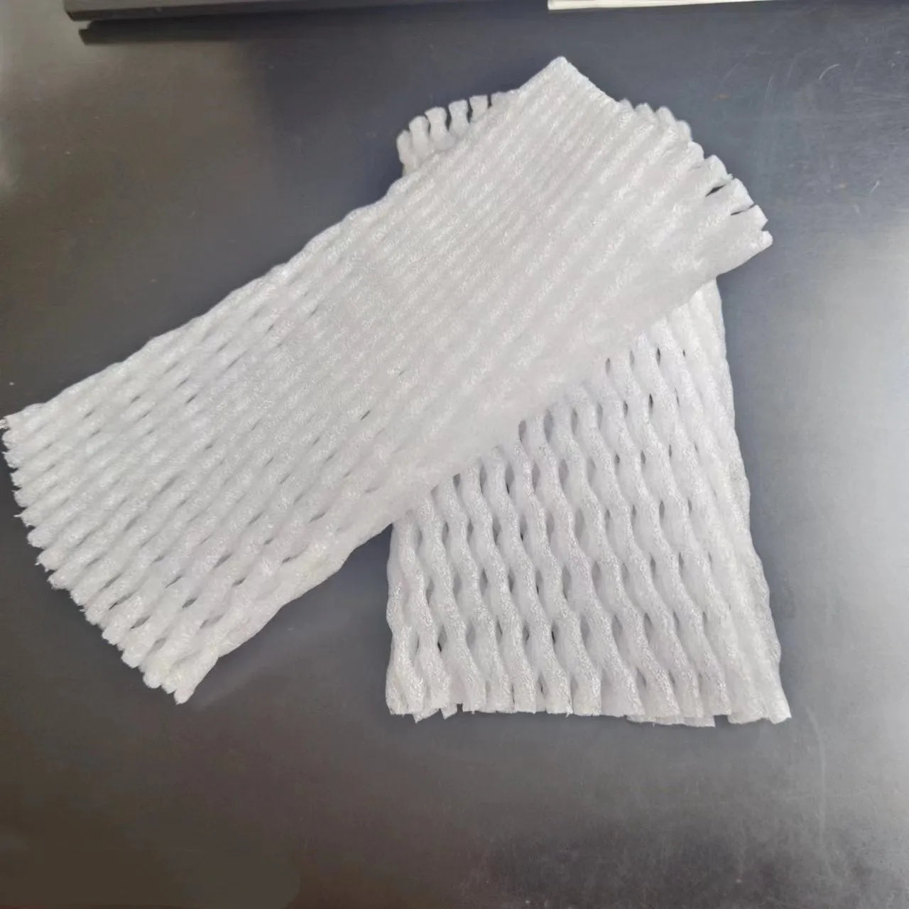 White foam protective net case for fruits showing mesh texture and size options