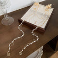 Gold women's hairpin with pearl diamond flower decoration and long acrylic tassel.