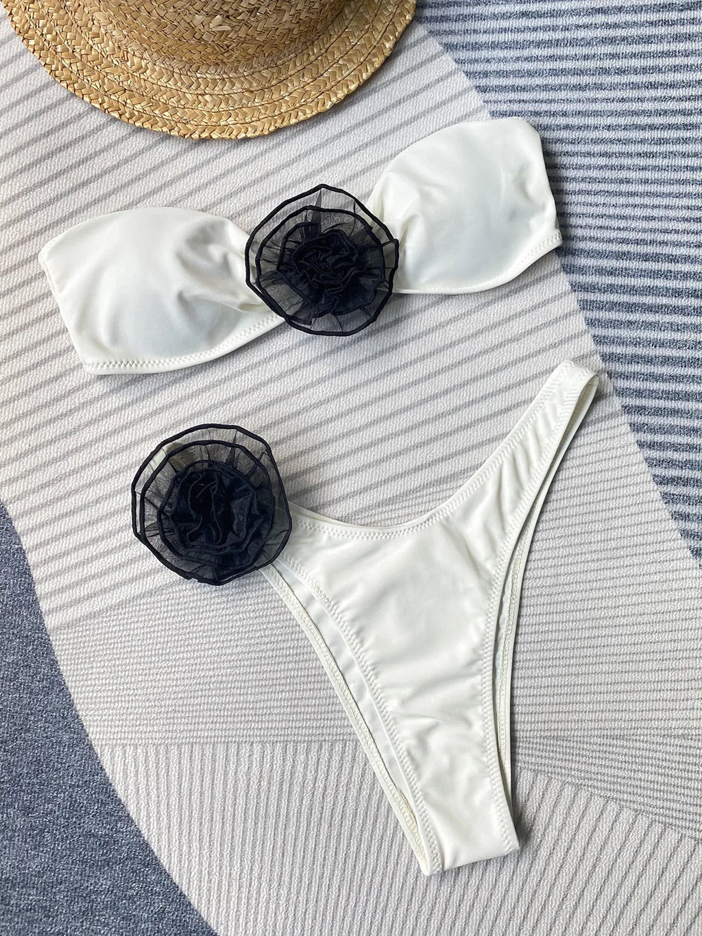Black and white striped bikini swimsuit with a tube top and a split skirt bottom.