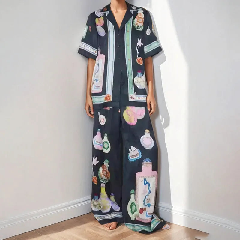 Black women's cardigan set with cartoon pattern, includes top with regular sleeves and matching trousers