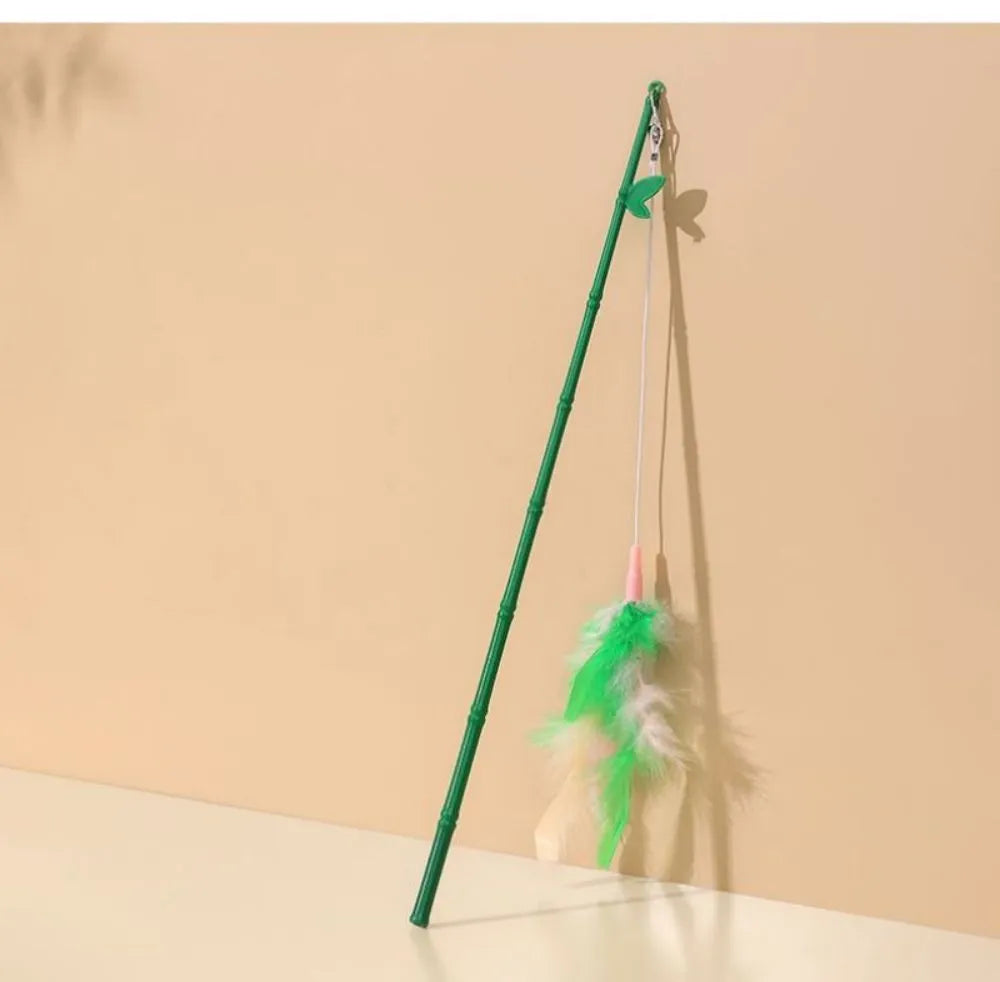 Green interactive cat wand toy with feathers and a bell on a durable plastic handle.