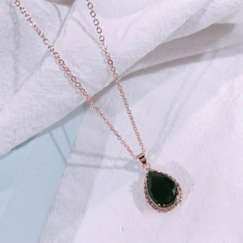 Women's rose gold electroplated rhinestone necklace with geometric water drop pendant in pink colour